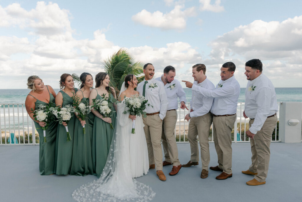 bridal party portraits in front of the water