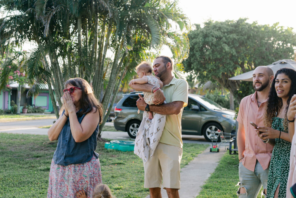Family watching the surprise backyard proposal