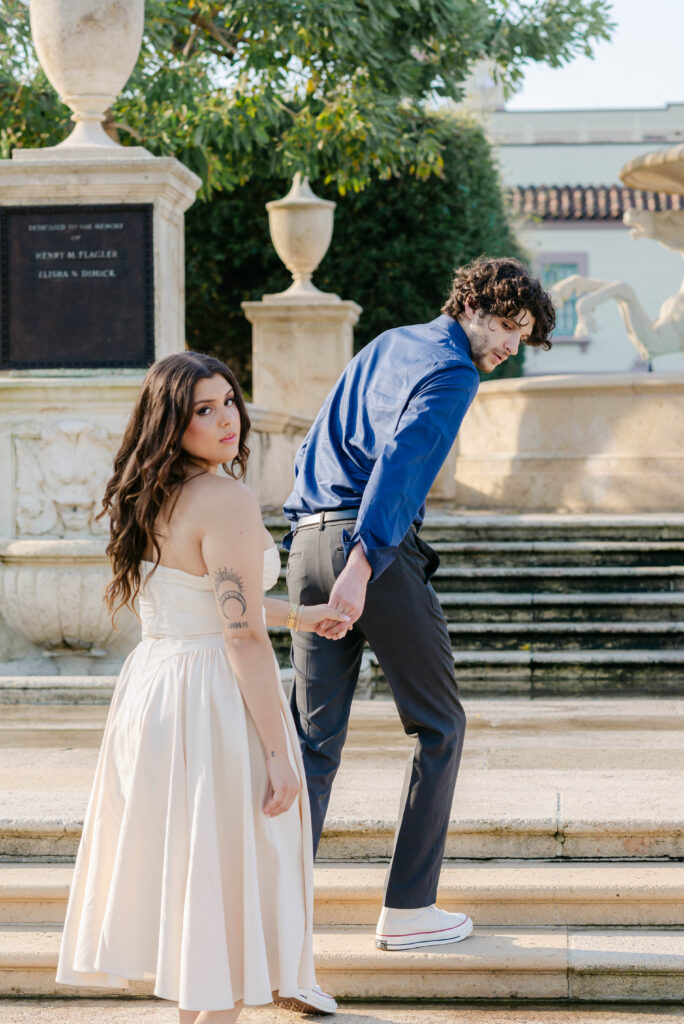 Romantic candid of couple walking up the steps on the avenue