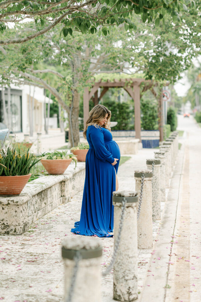 Backlit silhouette of pregnant woman under a tree