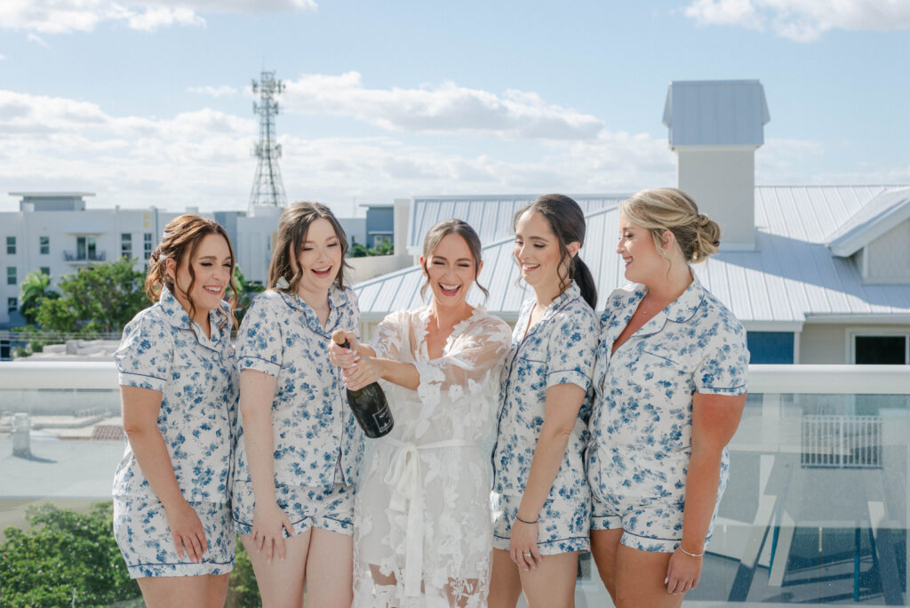 Popping champagne pre-wedding in hotel suite