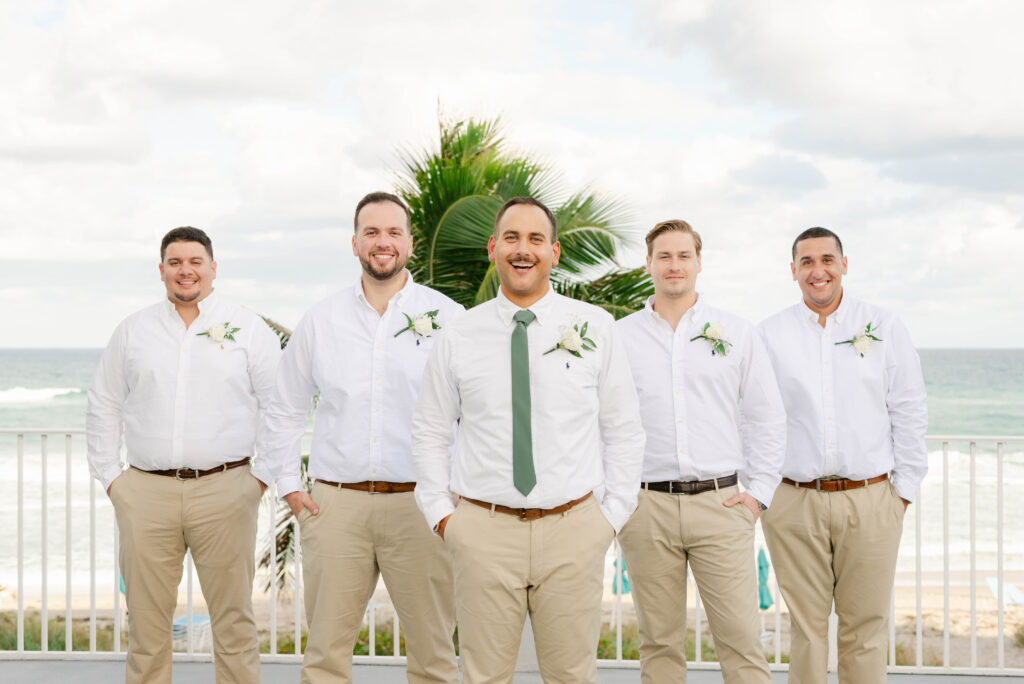 groom smiling with his groomsmen at the boca highland beach club