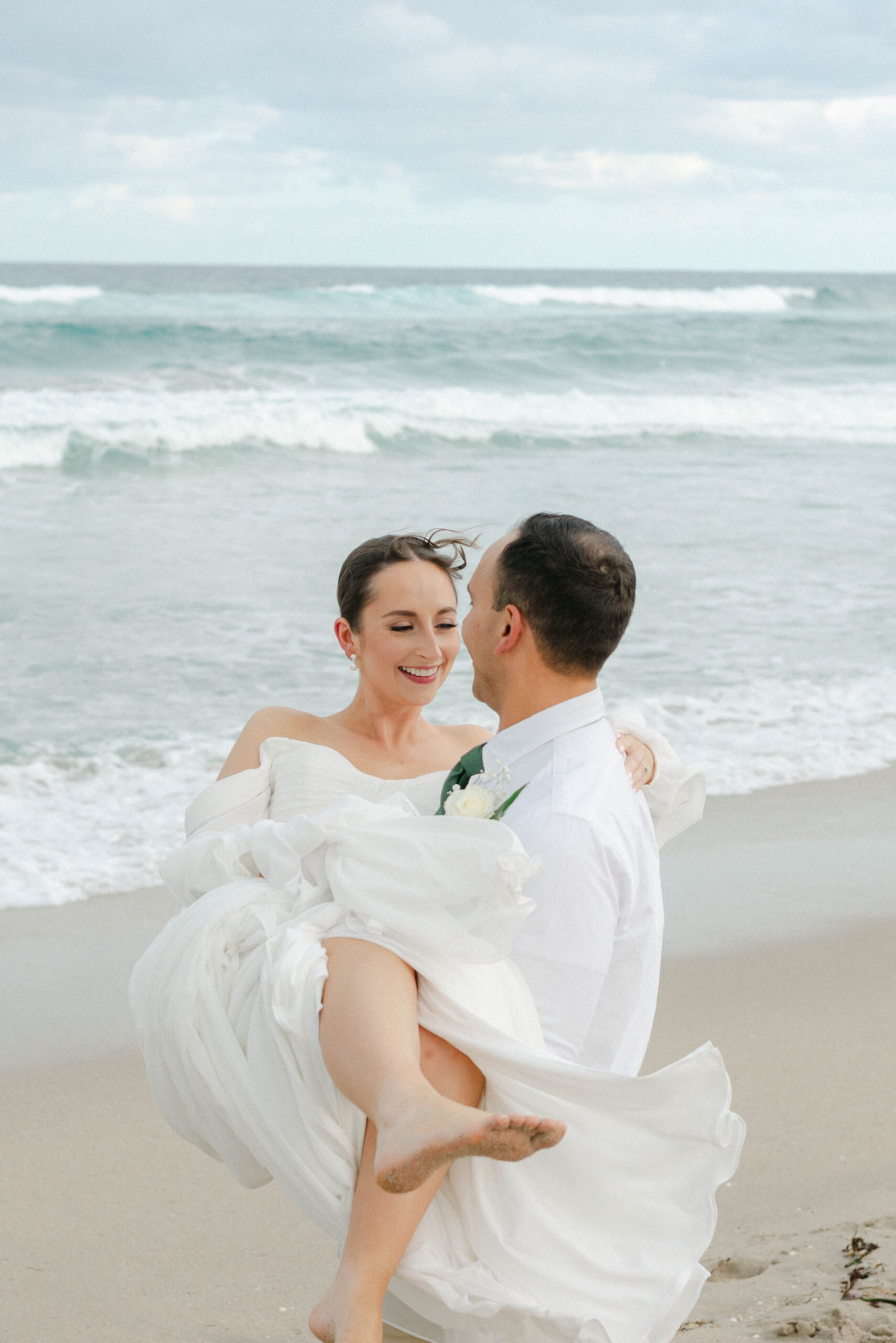 bride and groom posing on the beach in south florida
