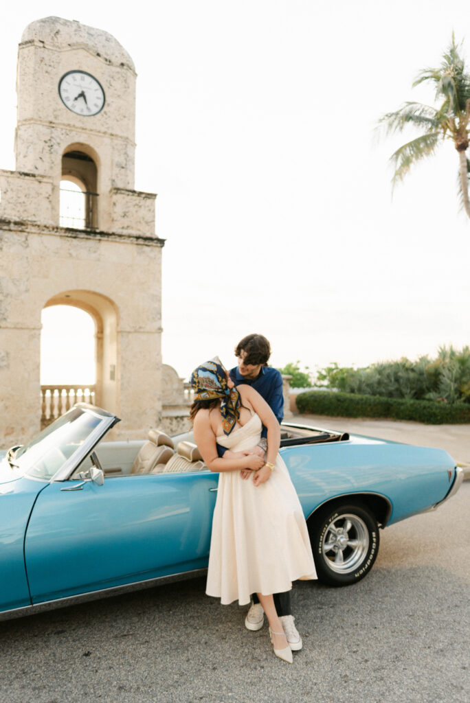 Wide shot of couple in front of Worth Avenue clock tower